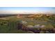 Expansive aerial view showcasing a luxury community and the beautifully manicured golf course at 16800 Bolsena Dr, Montverde, FL 34756