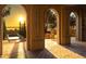 Inviting outdoor space with tile flooring, stone arches, and a tranquil pool overlooking a picturesque sunset view at 16800 Bolsena Dr, Montverde, FL 34756
