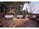 Inviting outdoor living space with a brick fire pit, comfortable seating, and mature trees at 17308 Pesce Loop, Montverde, FL 34756