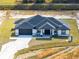 Aerial view of a single-story house with a dark gray roof and white walls at 20316 Sheldon St, Orlando, FL 32833