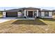 Single-story house with a dark-colored garage door and light-colored exterior at 20316 Sheldon St, Orlando, FL 32833