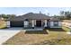 House exterior features a dark roof, white walls, and a dark brown door at 20316 Sheldon St, Orlando, FL 32833