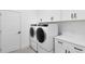 Laundry room with washer, dryer, and white cabinets at 20316 Sheldon St, Orlando, FL 32833