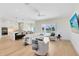 Open living area with hardwood floors, white sofas, and a view into the kitchen at 20316 Sheldon St, Orlando, FL 32833