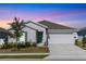 One-story home with light gray siding, green door, and two-car garage at 2037 Freemark St, Osteen, FL 32764