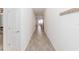 Long hallway with wood-look tile floors and coat rack at 2037 Freemark St, Osteen, FL 32764