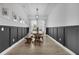 Dining room with a farmhouse table and dark wainscoting at 210 Hammock Preserve Loop, Winter Garden, FL 34787