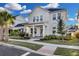 Two-story house with a front porch, landscaping, and sidewalk at 210 Hammock Preserve Loop, Winter Garden, FL 34787