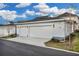 Two-car garage with white siding and lights at 210 Hammock Preserve Loop, Winter Garden, FL 34787