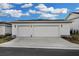 Two-car garage with white siding and lights at 210 Hammock Preserve Loop, Winter Garden, FL 34787