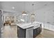 Modern kitchen with white cabinets, a large island, and stainless steel appliances at 210 Hammock Preserve Loop, Winter Garden, FL 34787