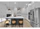 Modern kitchen with white cabinets, a large island, and stainless steel appliances at 210 Hammock Preserve Loop, Winter Garden, FL 34787