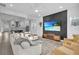 Living room with sectional sofa and a view of the kitchen at 210 Hammock Preserve Loop, Winter Garden, FL 34787