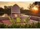 Brick fireplace with seating area overlooking a lake at sunset at 210 Hammock Preserve Loop, Winter Garden, FL 34787