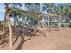 Wooden playground with swings and play area, surrounded by trees at 210 Hammock Preserve Loop, Winter Garden, FL 34787