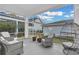 Peaceful screened porch with string lights and wicker chairs at 210 Hammock Preserve Loop, Winter Garden, FL 34787