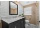 Modern bathroom boasts a black vanity with marble countertop and subway tile walls at 213 Oakland Ave, Sanford, FL 32773