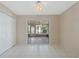 Open bedroom featuring white tile flooring and an adjoining sunroom at 213 Oakland Ave, Sanford, FL 32773