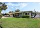 Attractive single-story home with a well-manicured lawn and lovely landscaping under a bright sky at 213 Oakland Ave, Sanford, FL 32773