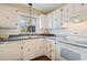 Charming kitchen featuring white cabinetry, laminate countertops, and a window above the sink at 213 Oakland Ave, Sanford, FL 32773