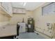 Utility room with water heater, utility sink, and overhead storage at 213 Oakland Ave, Sanford, FL 32773