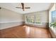 Bright living room with hardwood floors, ceiling fan, and a large window offering abundant natural light at 213 Oakland Ave, Sanford, FL 32773