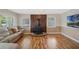 Cozy living room featuring fireplace, natural light, and hardwood floors at 213 Oakland Ave, Sanford, FL 32773