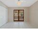 Bright room with tile floors, a ceiling fan, and French doors at 213 Oakland Ave, Sanford, FL 32773