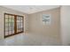 Bright room with tile floors, a ceiling fan, and double doors leading to sun room at 213 Oakland Ave, Sanford, FL 32773