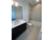 Clean bathroom with single vanity, tub, and modern fixtures at 2229 Valentine Aly, Orlando, FL 32804