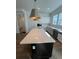 Kitchen island with white quartz countertop and dark base cabinets at 2229 Valentine Aly, Orlando, FL 32804