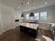 Modern kitchen with white cabinets, large island, and stainless steel appliances at 2229 Valentine Aly, Orlando, FL 32804