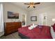 Bedroom with king-size bed, dresser, and TV at 2549 Archfeld Blvd, Kissimmee, FL 34747