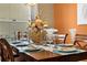 Formal dining room with wood table, place settings, and centerpiece at 2549 Archfeld Blvd, Kissimmee, FL 34747