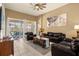 Relaxing living room with leather furniture and access to pool area at 2549 Archfeld Blvd, Kissimmee, FL 34747