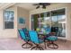 Covered patio with table and chairs for outdoor dining at 2549 Archfeld Blvd, Kissimmee, FL 34747