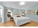 Bright bedroom with a king-size bed and light blue walls at 2610 Autumn Creek Cir, Kissimmee, FL 34747