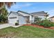 Single-story house with a two-car garage and landscaped lawn at 2610 Autumn Creek Cir, Kissimmee, FL 34747