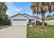 Front view of a single story house with a two-car garage at 2610 Autumn Creek Cir, Kissimmee, FL 34747