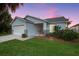 Single story home with a two car garage and well maintained landscaping at 2610 Autumn Creek Cir, Kissimmee, FL 34747