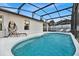 Inviting kidney-shaped pool with screened enclosure and lounge chairs at 2610 Autumn Creek Cir, Kissimmee, FL 34747