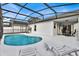 Relaxing pool area with screened enclosure and patio furniture at 2610 Autumn Creek Cir, Kissimmee, FL 34747