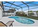 Inviting kidney-shaped pool with screened patio and lounge chairs at 2610 Autumn Creek Cir, Kissimmee, FL 34747