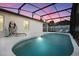 Relaxing kidney-shaped pool with a screened enclosure at night at 2610 Autumn Creek Cir, Kissimmee, FL 34747