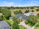 Aerial view of a house with a gray roof and driveway at 2764 Kingston Ridge Dr, Clermont, FL 34711