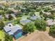 Aerial view of a neighborhood showing houses and a pool at 2764 Kingston Ridge Dr, Clermont, FL 34711