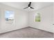 Bedroom with carpet, ceiling fan, and two windows at 2764 Kingston Ridge Dr, Clermont, FL 34711