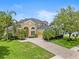 Two-story house with a large yard and palm trees at 2764 Kingston Ridge Dr, Clermont, FL 34711