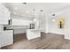 Modern kitchen with island, white cabinets, and stainless steel appliances at 2764 Kingston Ridge Dr, Clermont, FL 34711