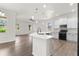 Modern kitchen with island, white cabinets, and stainless steel appliances at 2764 Kingston Ridge Dr, Clermont, FL 34711